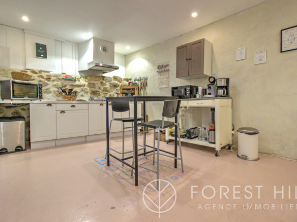 Kitchen in a property with stone walls and a modern worktop.