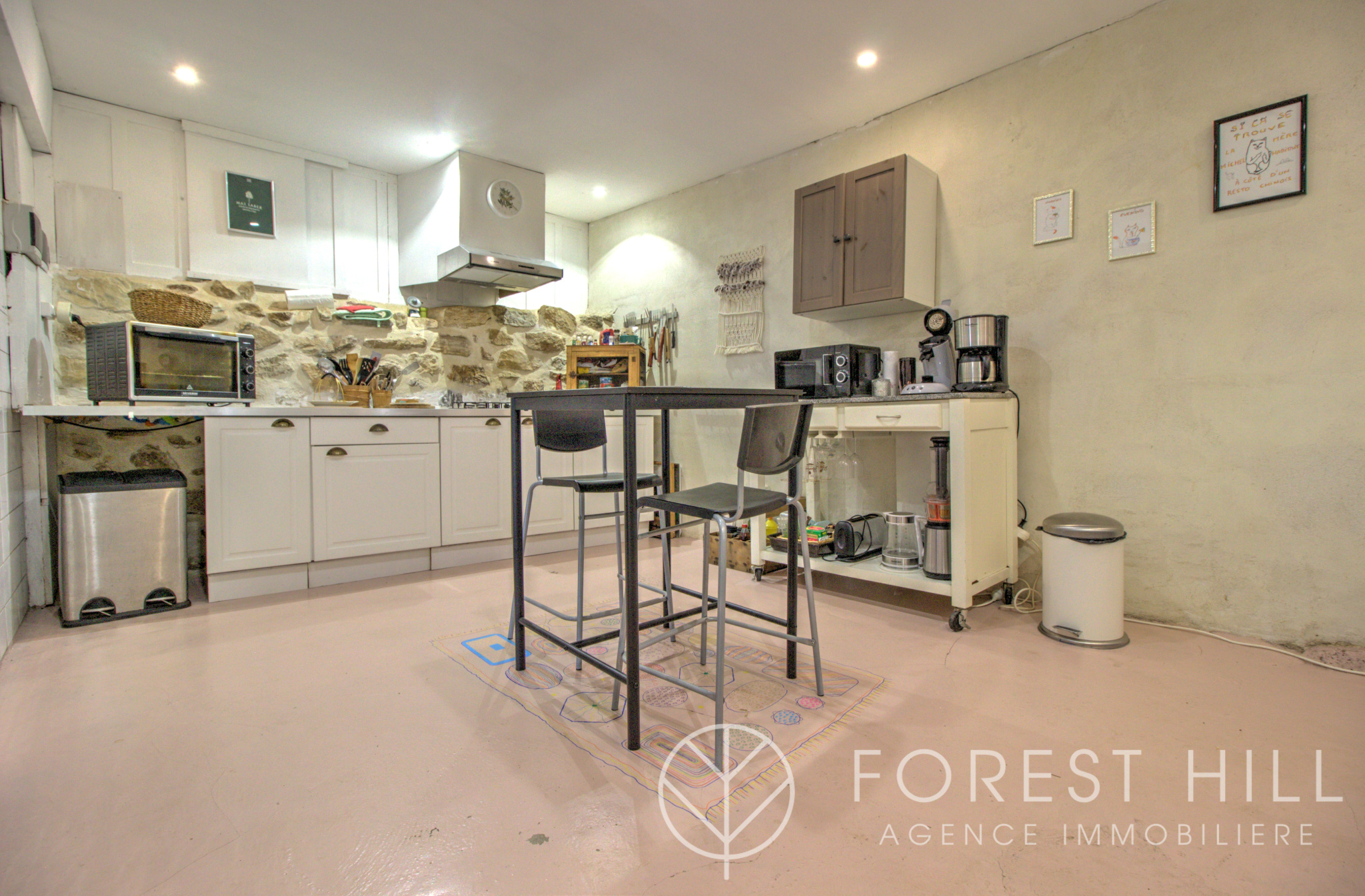 Kitchen in a property with stone walls and a modern worktop.