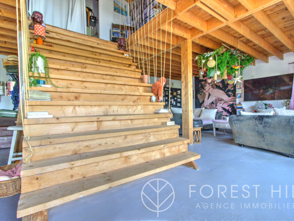Wooden staircase leading to a bright and decorated living space.