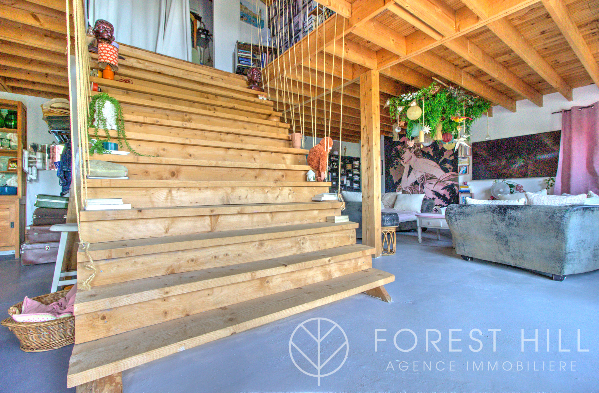 Wooden staircase leading to a bright and decorated living space.