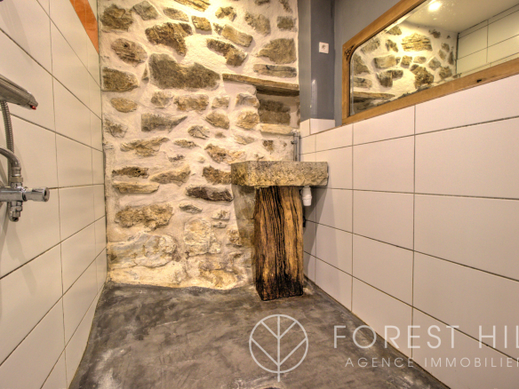 Bathroom with stone walls and wooden sink in a property in Montbolo.