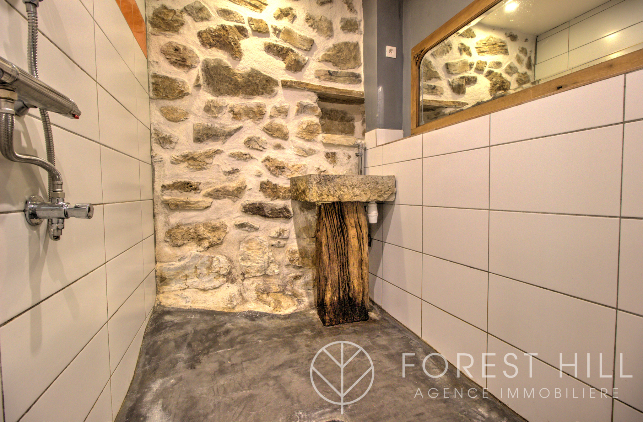Bathroom with stone walls and wooden sink in a property in Montbolo.