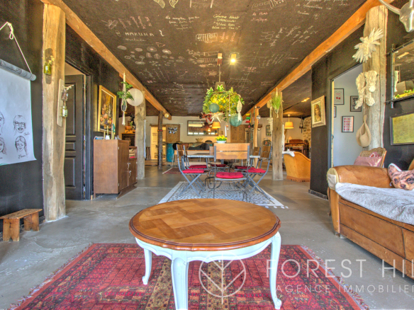 Interior of a property with a spacious living room, wooden furniture and various decorative elements.
