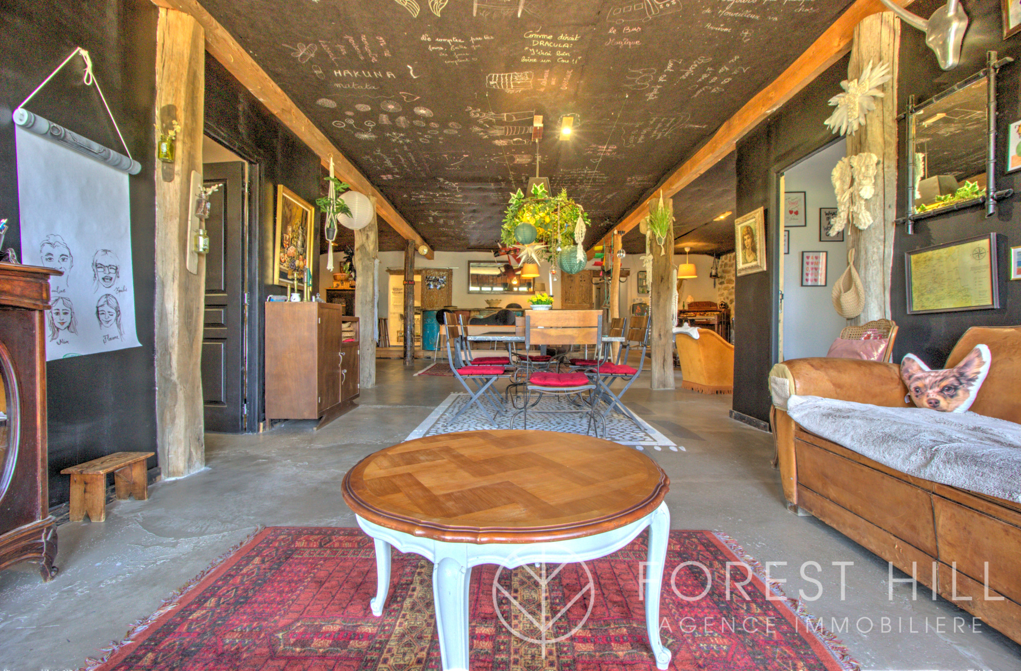 Interior of a property with a spacious living room, wooden furniture and various decorative elements.
