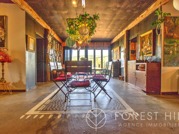 Interior of a property with chairs and paintings, natural lighting
