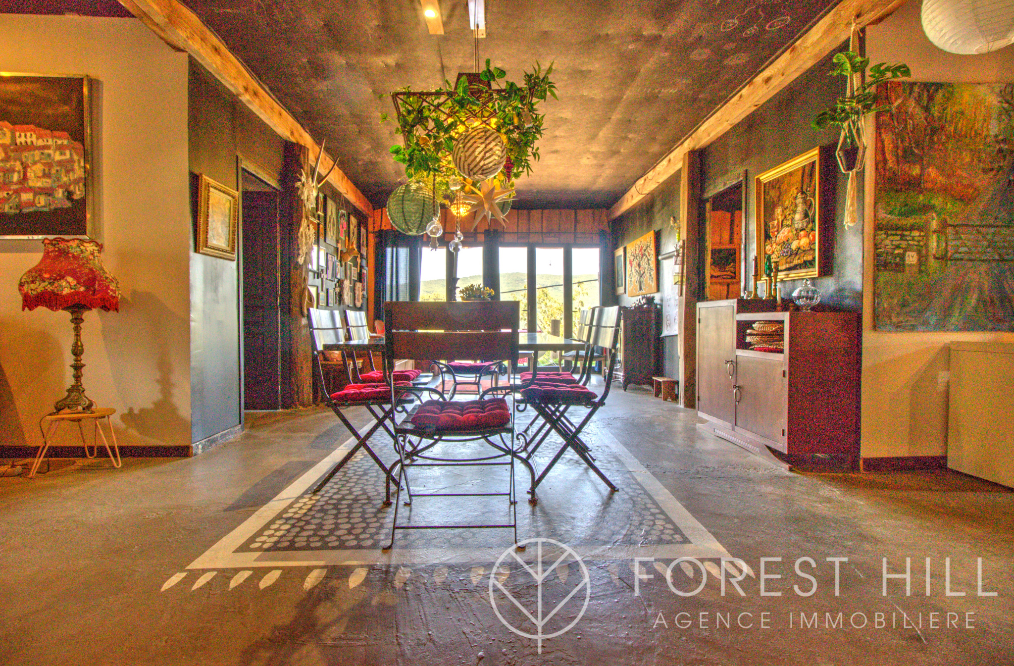 Interior of a property with chairs and paintings, natural lighting