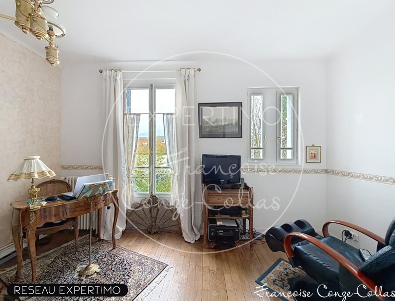 Interior of a millstone house with a bright living room and windows.