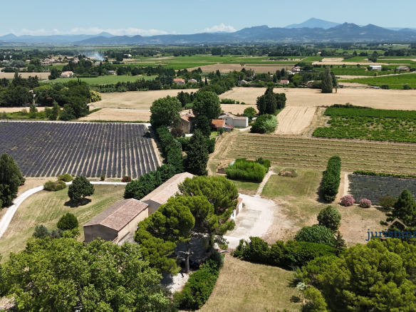 Aerial view of an 8-hectare property with vineyards and lavender fields in Camaret-sur-Aigues.