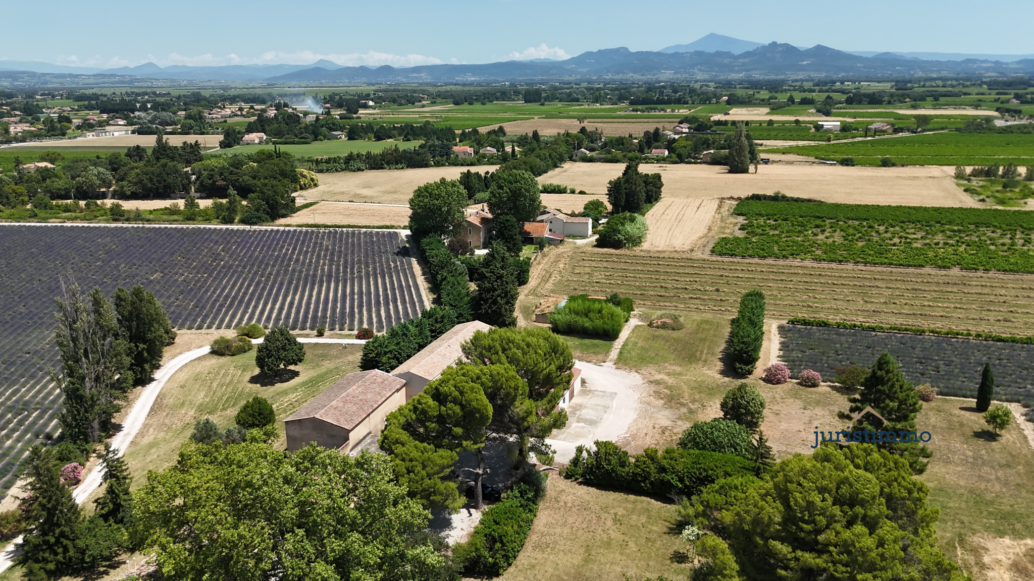 Elegant property in Provence Aerial view of an 8-hectare property with vineyards and lavender fields in Camaret-sur-Aigues.