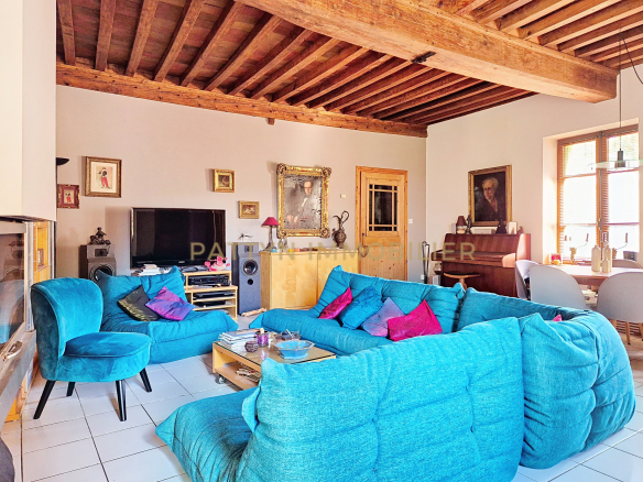 Interior of a house in Tramoyes with a spacious living room and comfortable furniture.