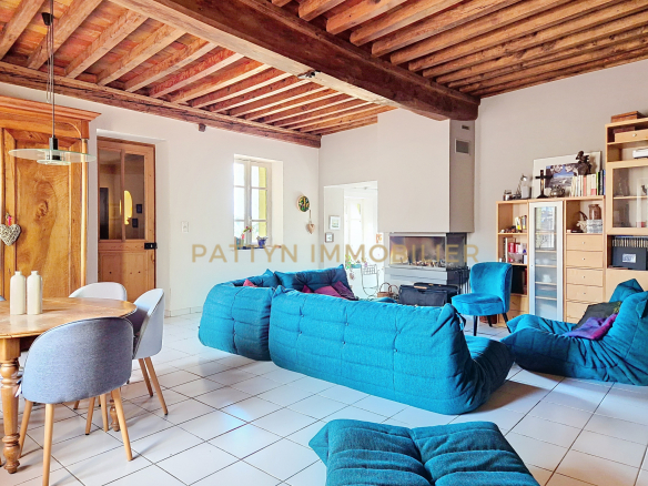 Interior of a house in Tramoyes with blue sofas and a fireplace.