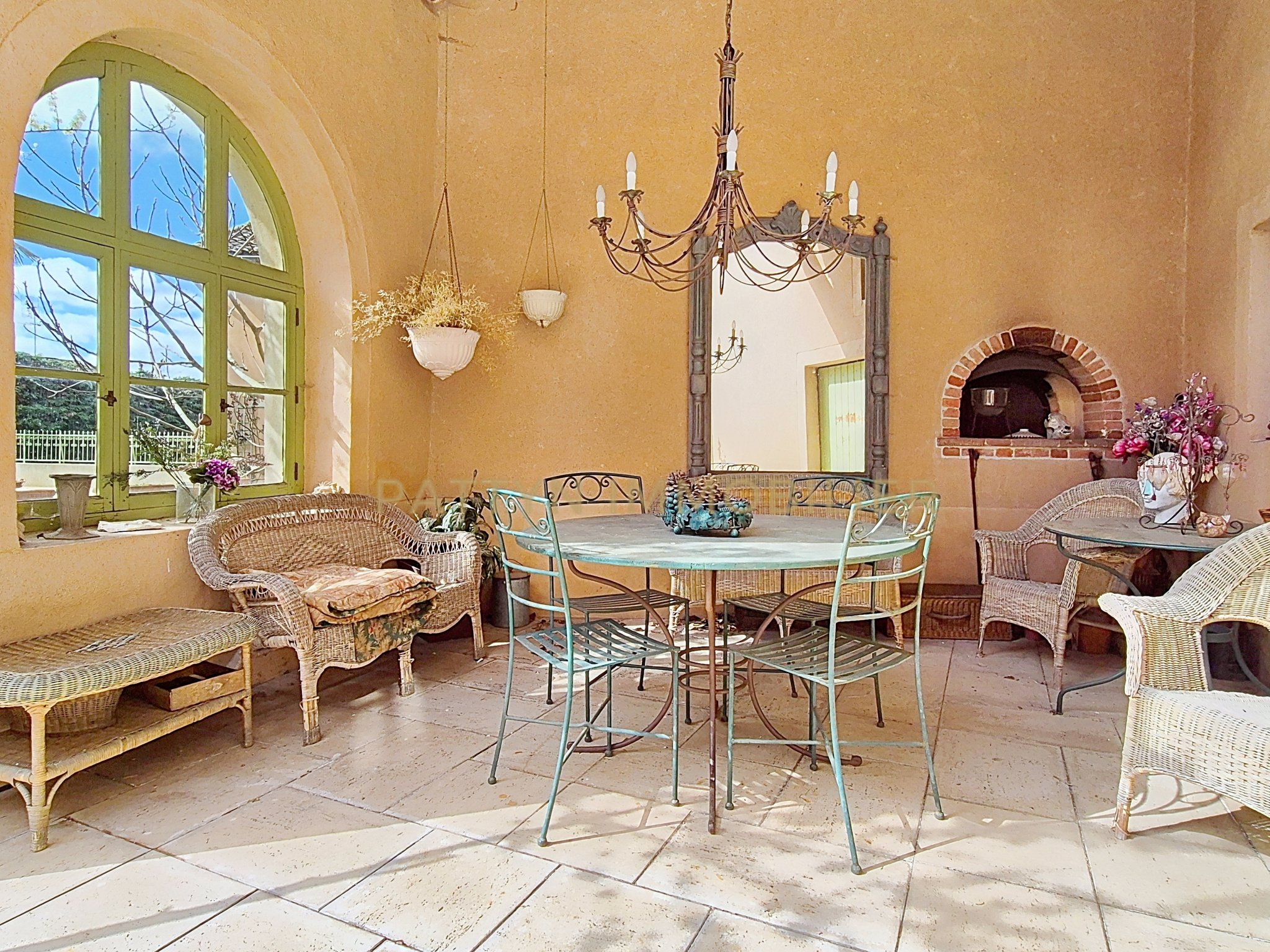 Living space in Tramoyes Interior of a house in Tramoyes with a dining area, wrought iron chairs and a bright living space.