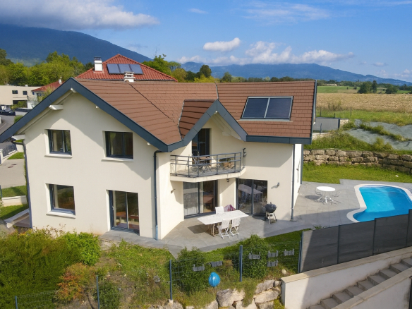 Maison individuelle de 280 m2 avec piscine à Chevry, vue sur la montagne.