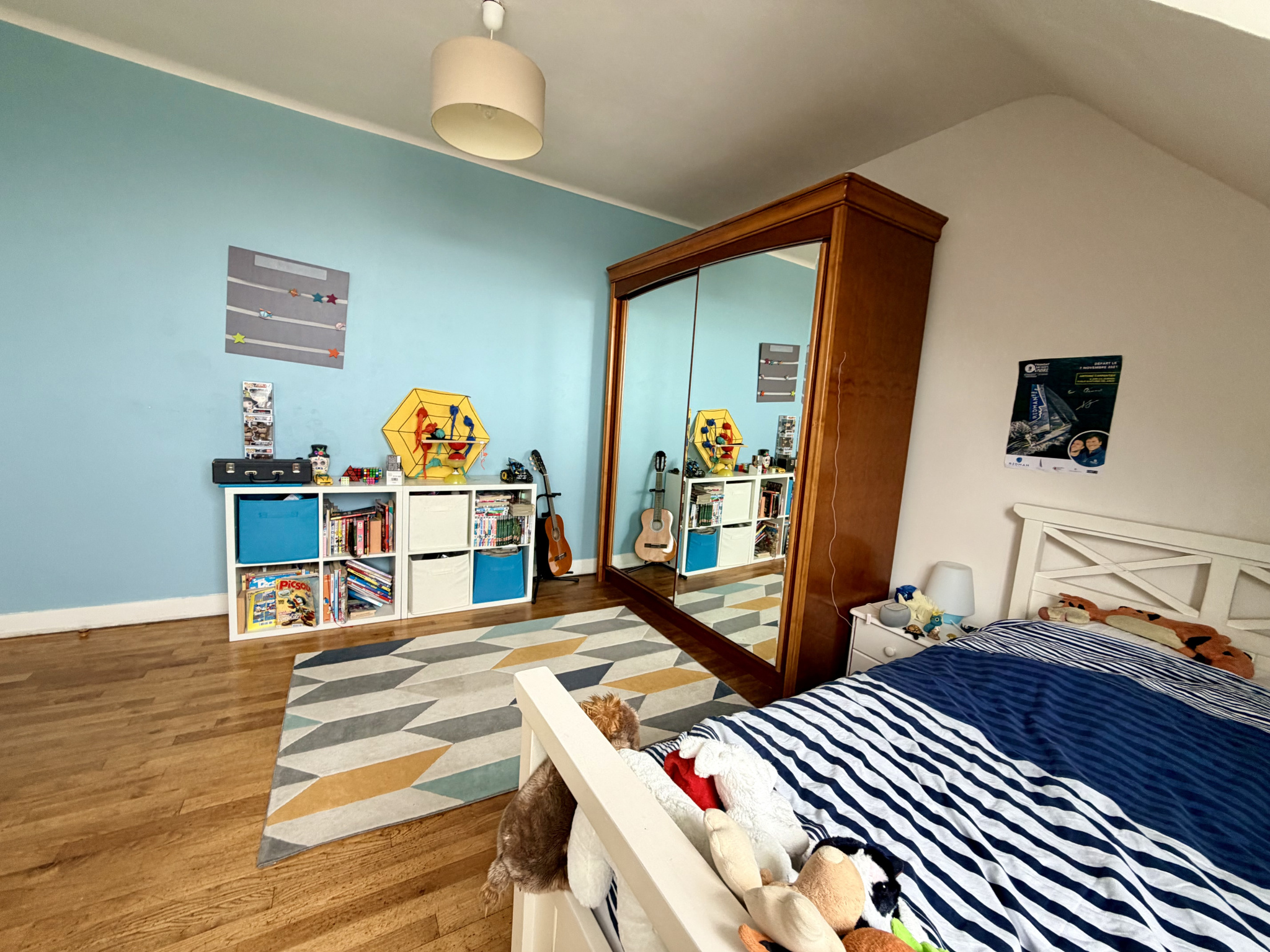 Bedroom in a renovated house with a bed, a mirror and shelves, Kerdrain district in Auray.