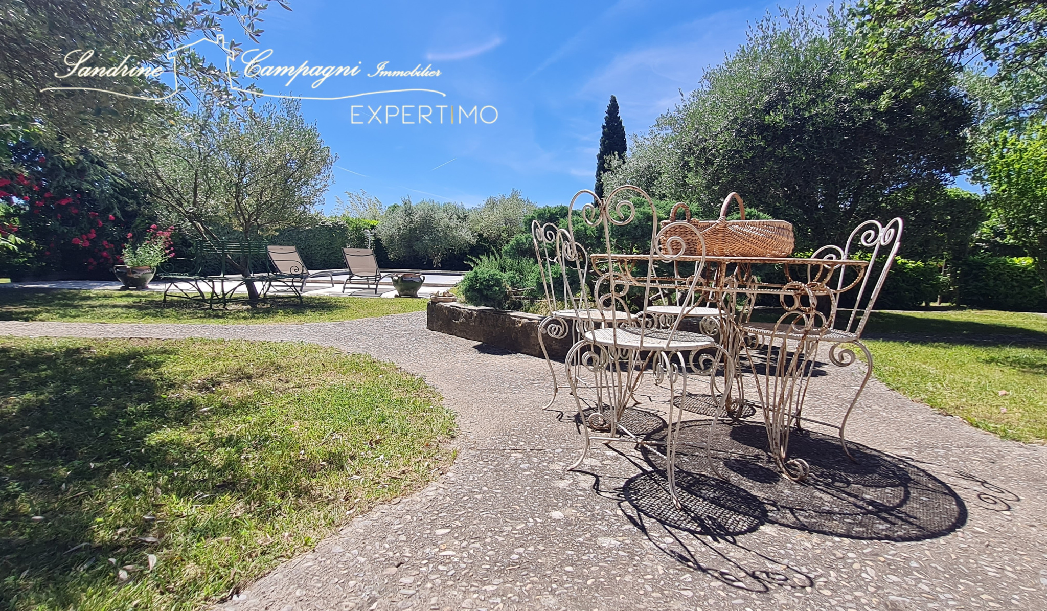 Terrace with wrought iron furniture and wooded garden in Mazan.