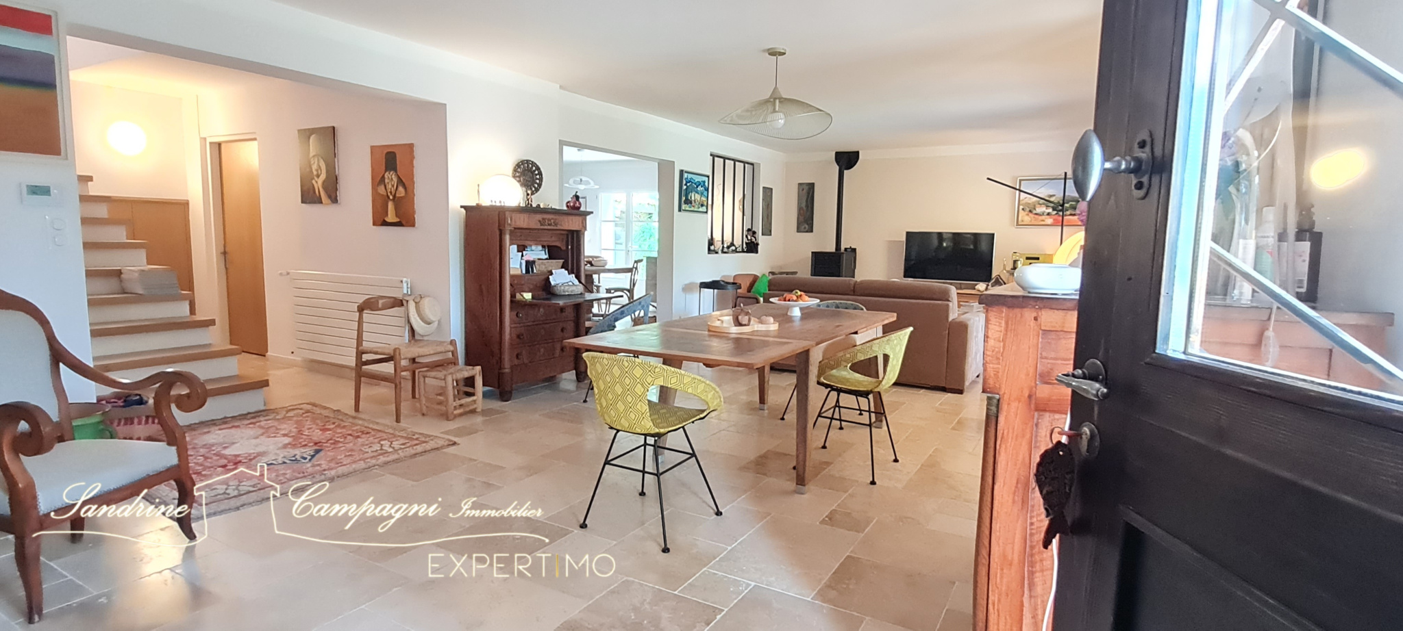 Interior of a renovated house with living room, dining room and open kitchen.