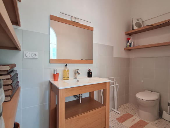 Modern bathroom with wooden sink and decorative tiles