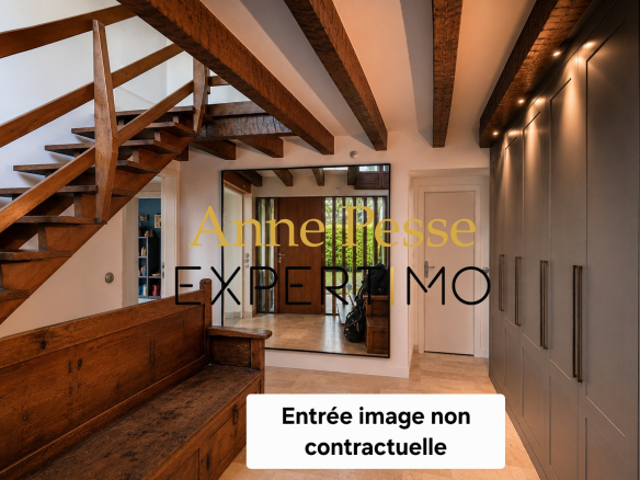 Interior of a modernist villa with wooden staircase and light walls in Saint-Maur-des-Fossés.