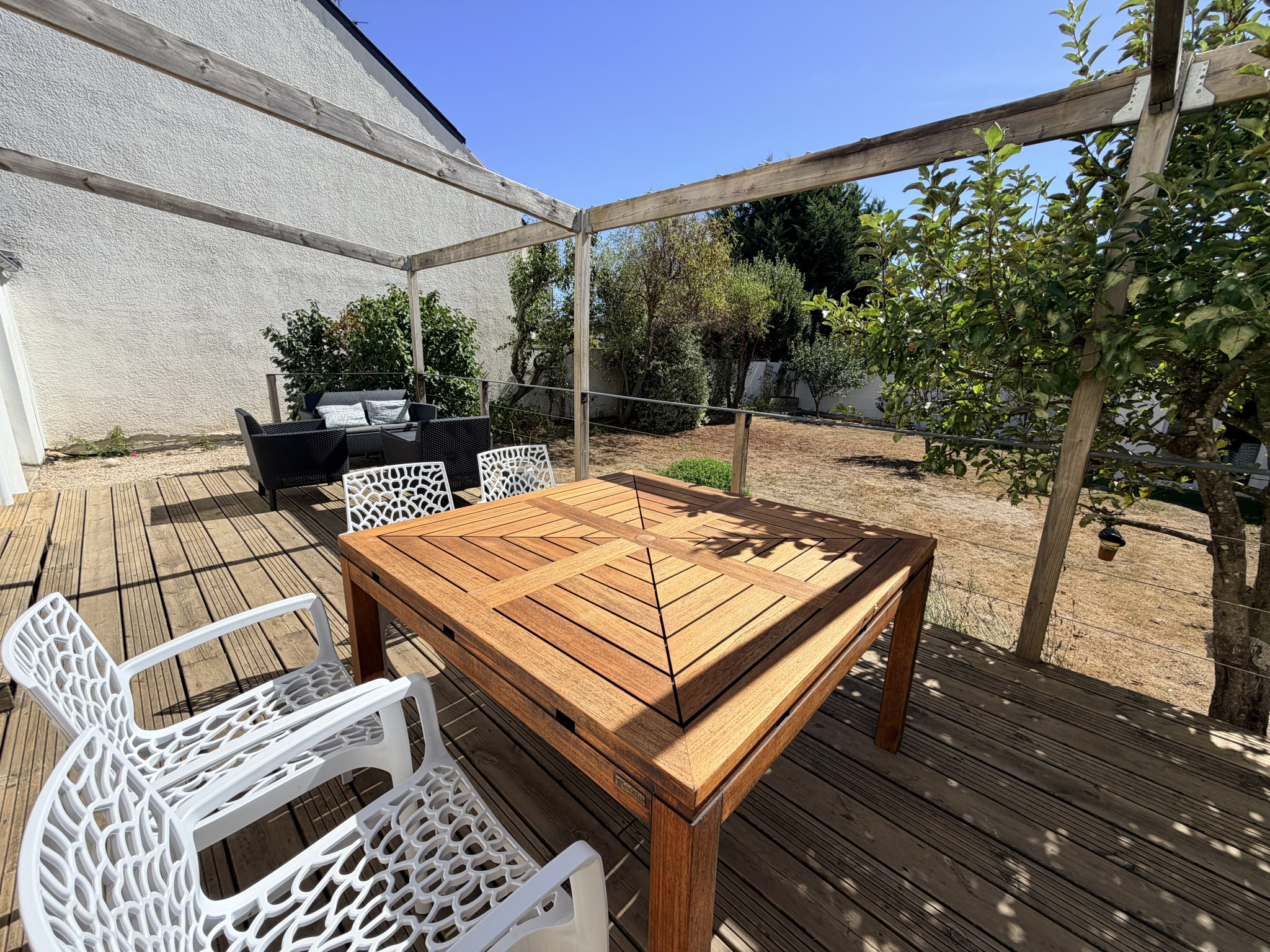 Terrasse en bois avec mobilier de jardin dans une maison rénovée à Auray, quartier Kerdrain.