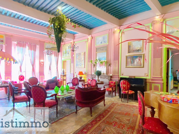 Interior of a private mansion with a living room decorated with antique furniture and paintings.