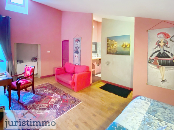 A room in a private mansion with a living room, an office, and wall decorations.
