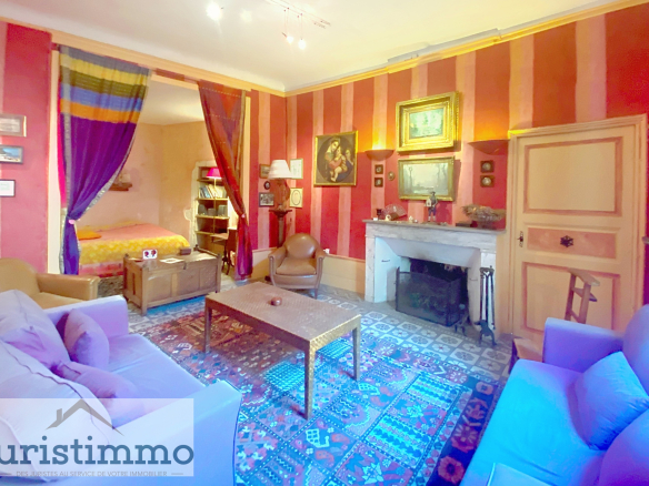 Interior of a private mansion with living room, fireplace and colorful decoration.