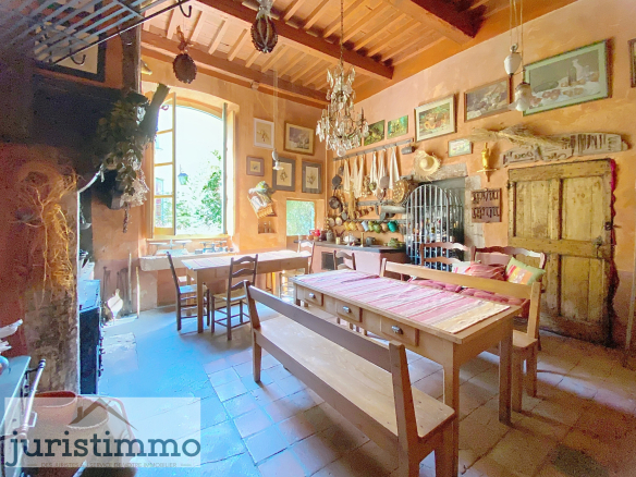 Interior of a rustic kitchen with wooden tables and wall decorations