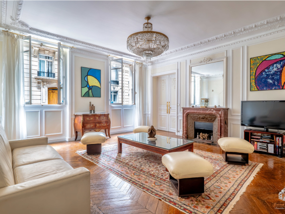 Interior of an elegant garden-level apartment in Paris with a bright living room and refined decor.