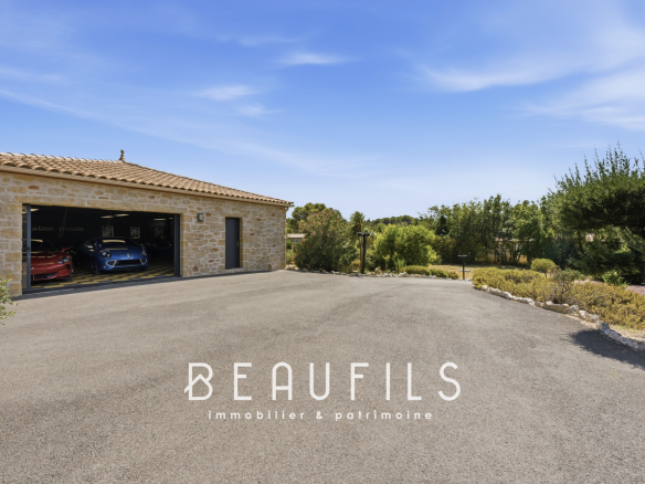 Exterior view of a property with garage and landscaped area, near Narbonne.