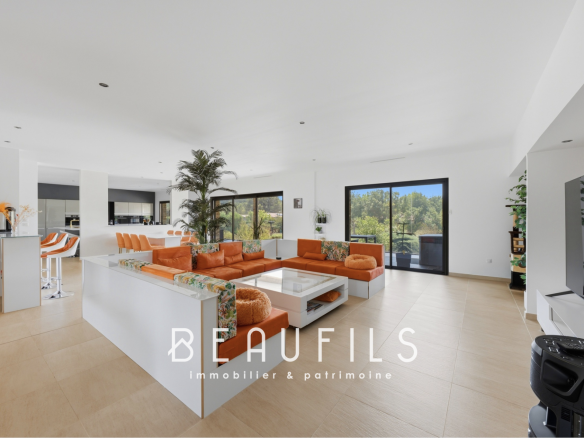 Interior of a modern villa with a spacious living room and open kitchen.