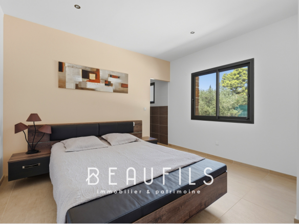 Room in a modern villa with a double bed and simple decor.