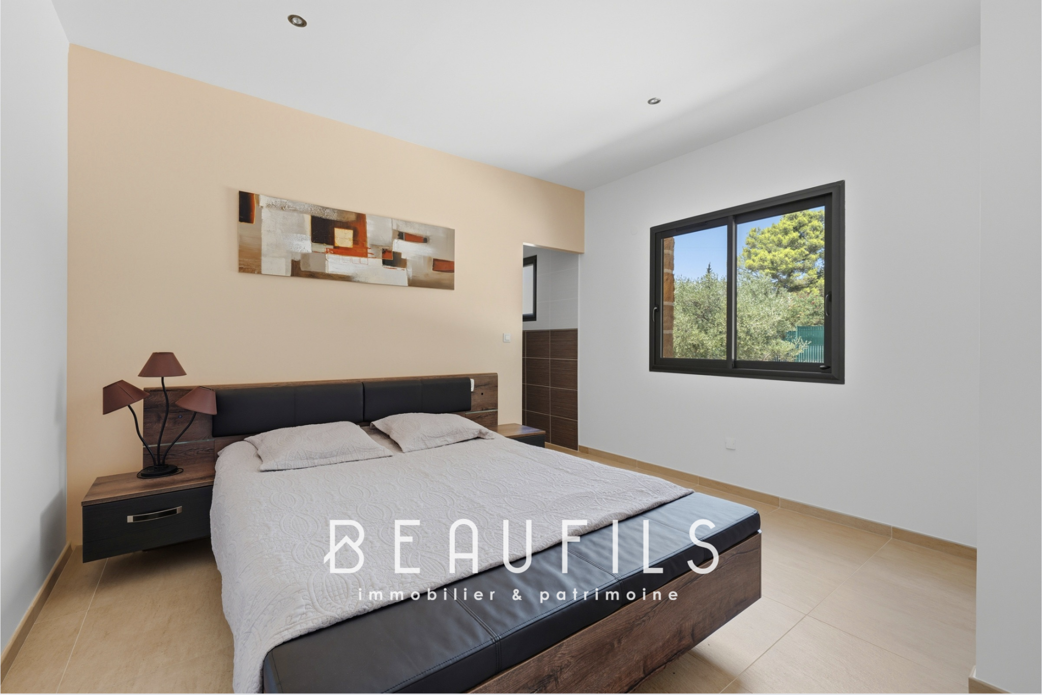Room in a modern villa with a double bed and simple decor.