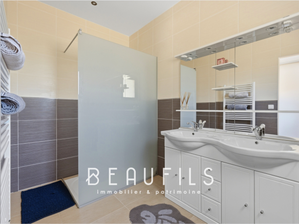 Modern bathroom with shower and double sink in a luxury villa.