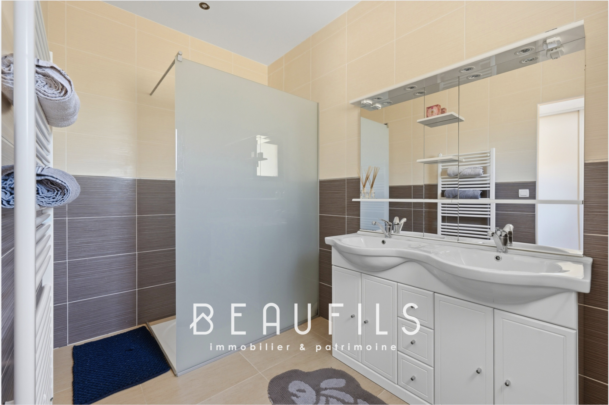 Modern bathroom with shower and double sink in a luxury villa.