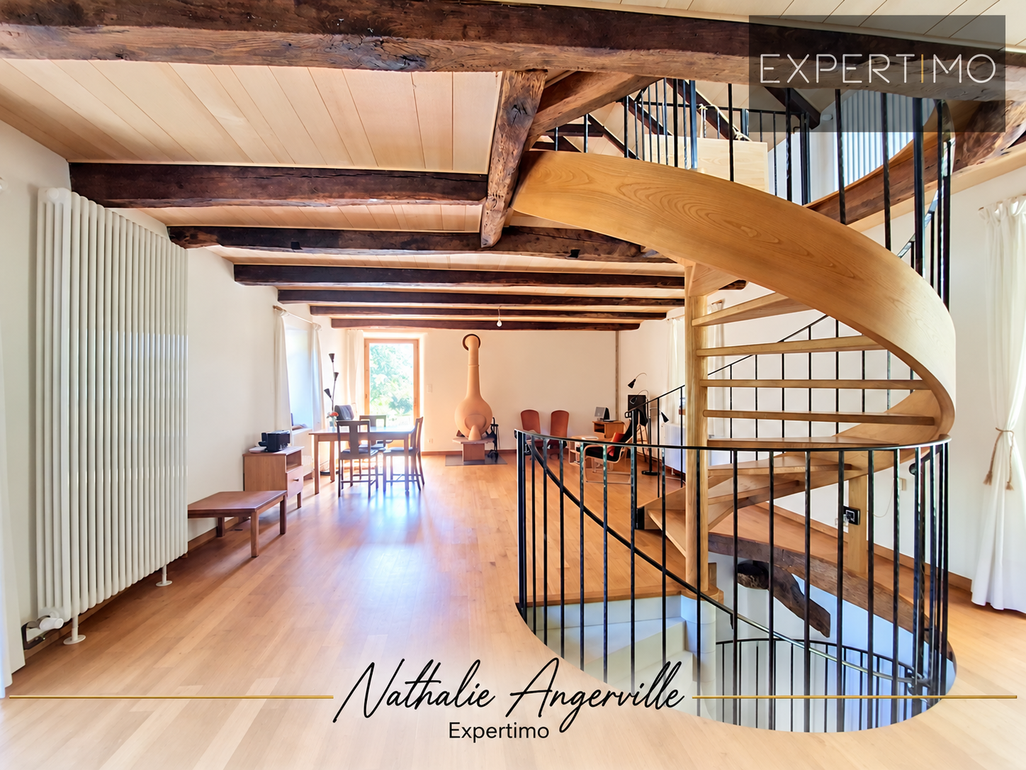 Interior of a property with a staircase Interior of a property with a wooden spiral staircase and exposed beams.
