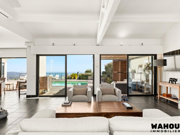 Interior of a modern villa overlooking the bay of Cannes, bright living room and access to the terrace.