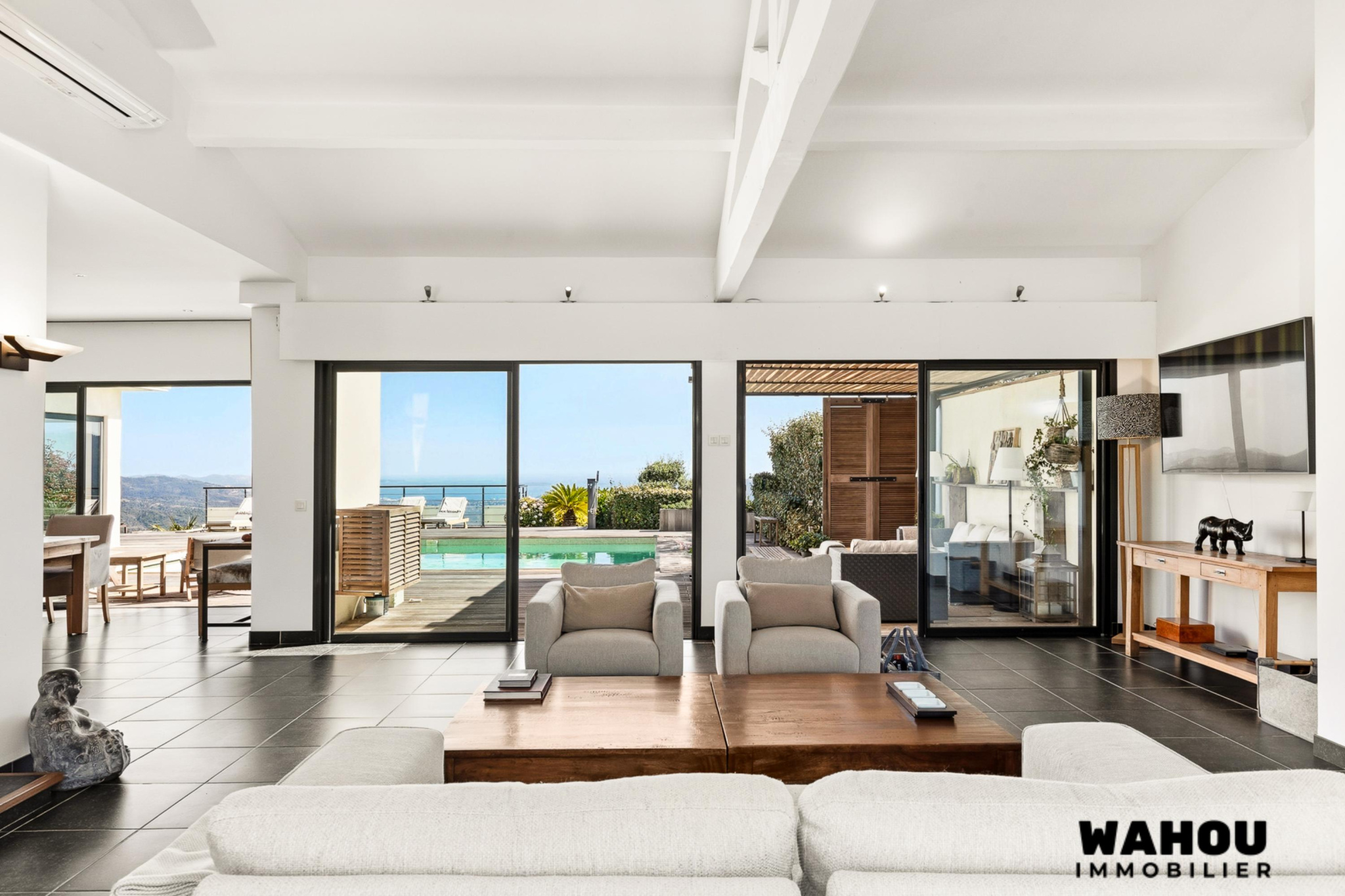 Interior of a modern villa overlooking the bay of Cannes, bright living room and access to the terrace.