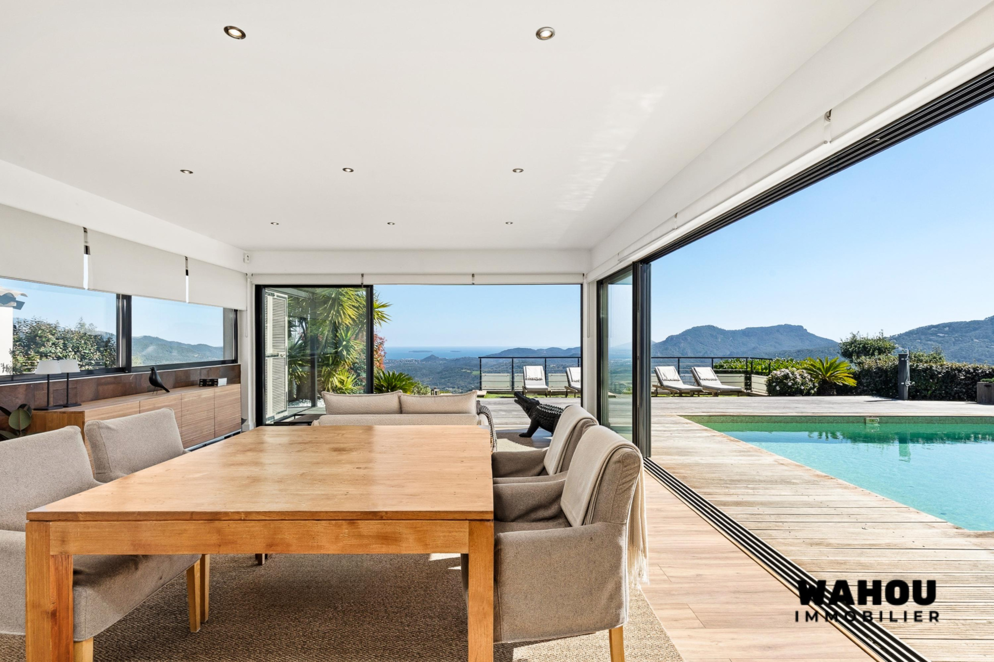 Interior of a modern villa with dining room and view of the Bay of Cannes.
