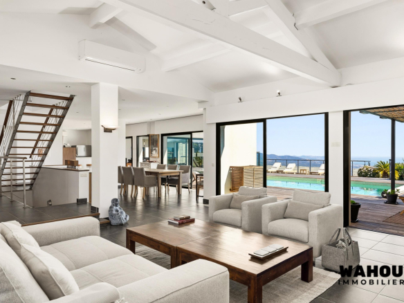 Interior of a modern architect-designed villa overlooking the Bay of Cannes, bright living room and outdoor swimming pool.
