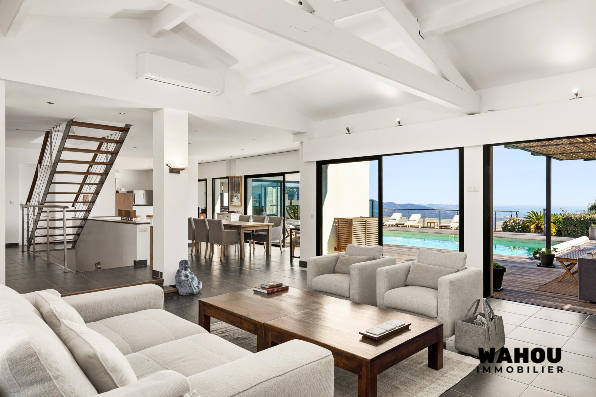 Interior of a modern architect-designed villa overlooking the Bay of Cannes, bright living room and outdoor swimming pool.