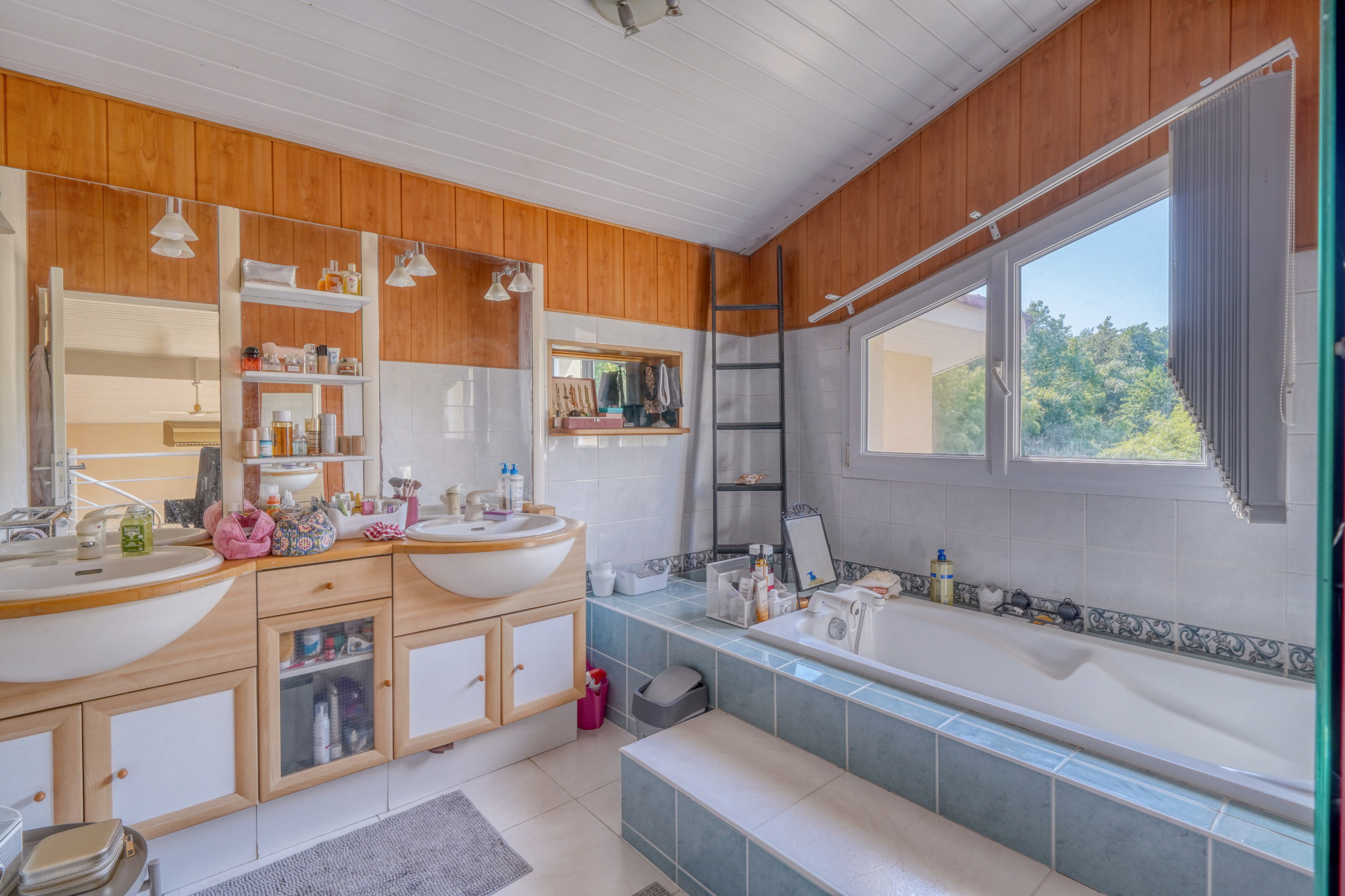 Salle de bains d’une maison familiale Salle de bains spacieuse avec baignoire et double vasque dans une maison familiale.
