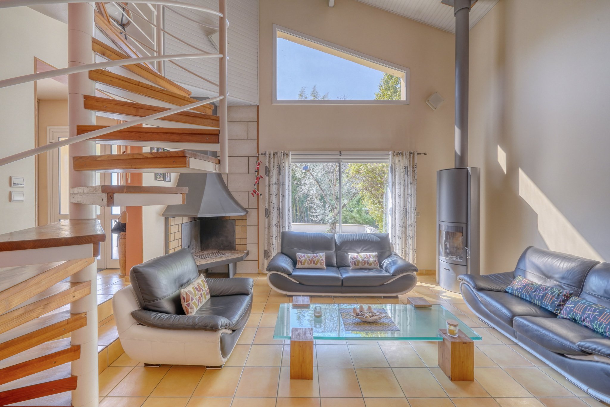 Salon d’une maison familiale à Montussan Intérieur d'une maison avec salon lumineux, cheminée et poêle à bois.