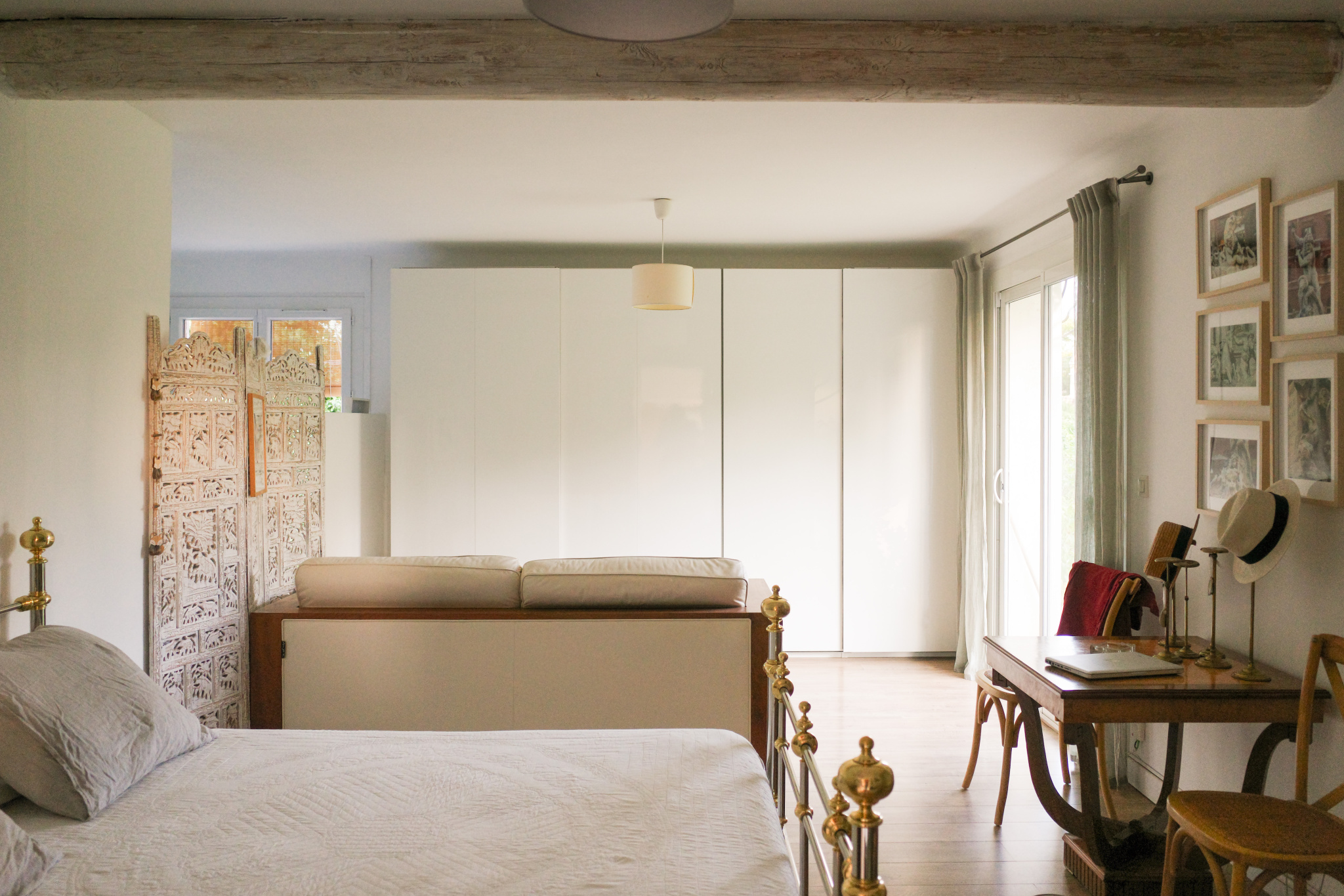Interior of a renovated house with bed, sofa and desk, L'Isle-sur-la-Sorgue.
