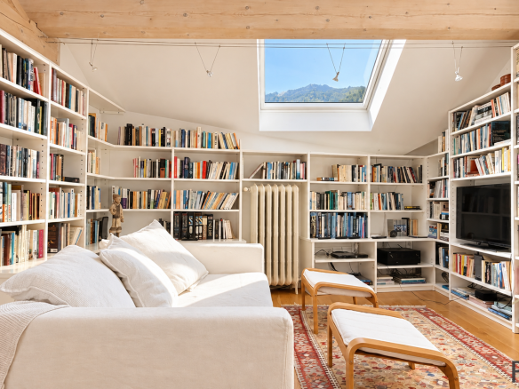 Interior of a stone house with library and bright living room in Sergy.