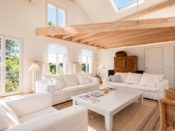 Interior of a stone house with a bright living room and modern furniture.