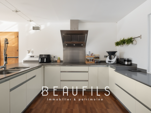 Modern kitchen in an architect-designed villa with clear worktops and integrated appliances.