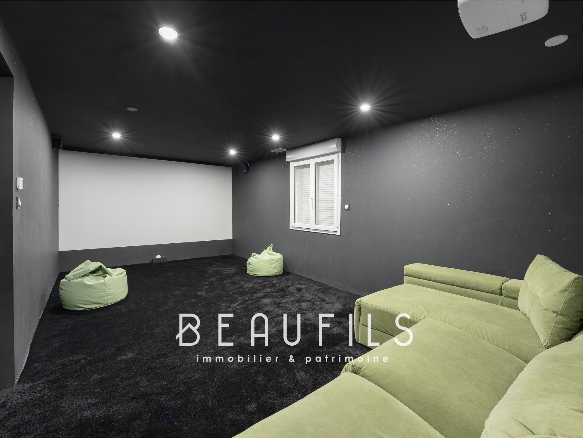 Modern recreation room Recreation room with green sofa and poufs, dark walls, modern lighting.