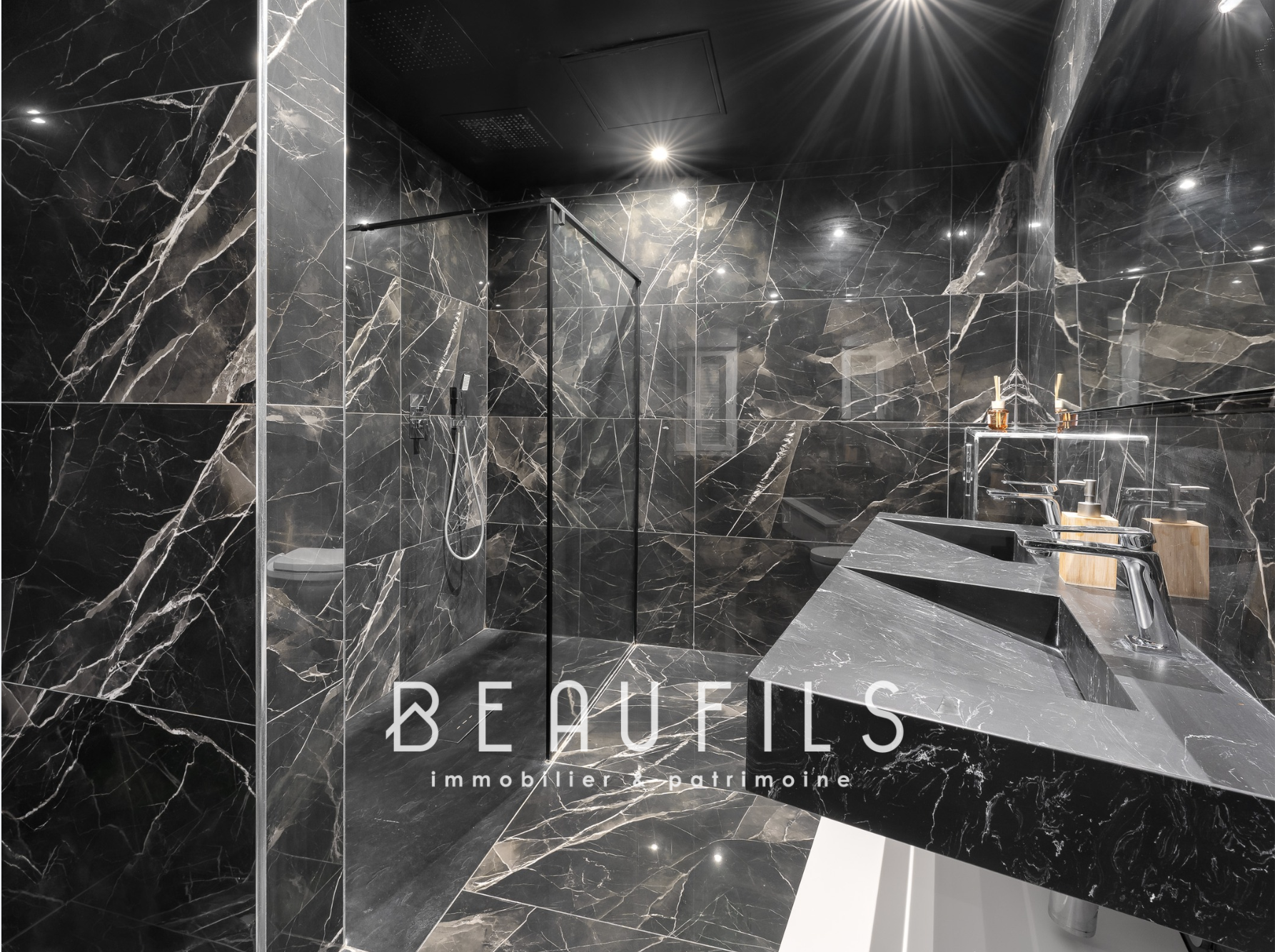 Black marble bathroom Modern bathroom with black marble tiles and walk-in shower.