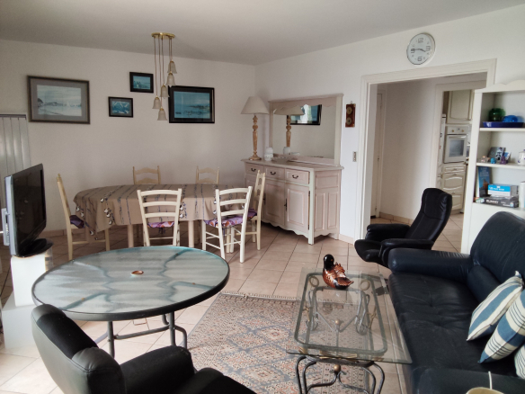 Interior of an apartment in Carnac with living room, dining room and kitchen.