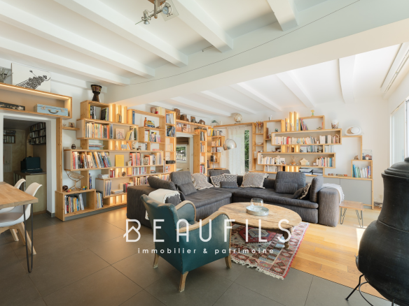 Interior of an architect-designed villa in Montferrier-sur-Lez, with a spacious living room and wooden shelves.